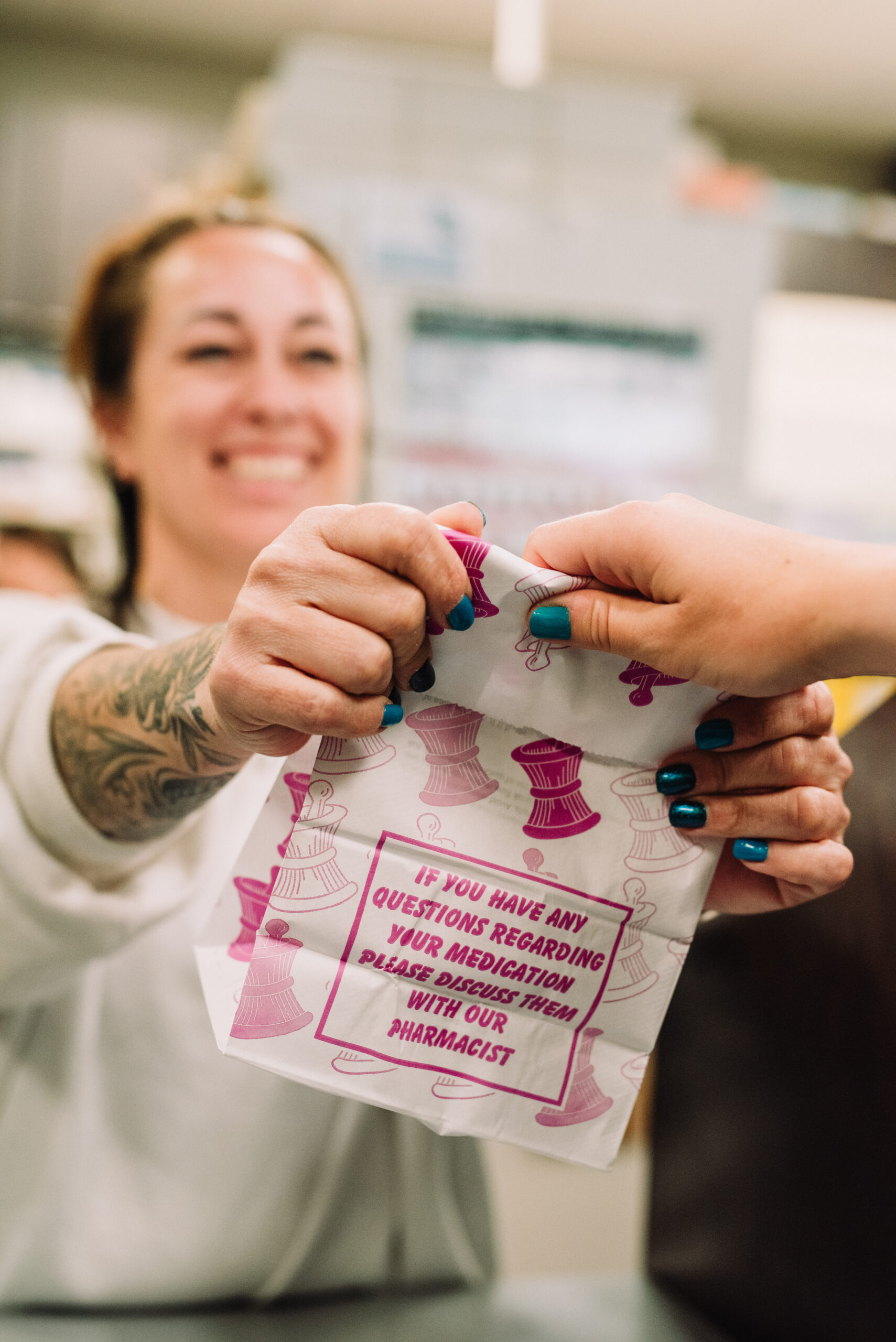 A technician handing a customer their specialty compounded medication in Kamloops BC.