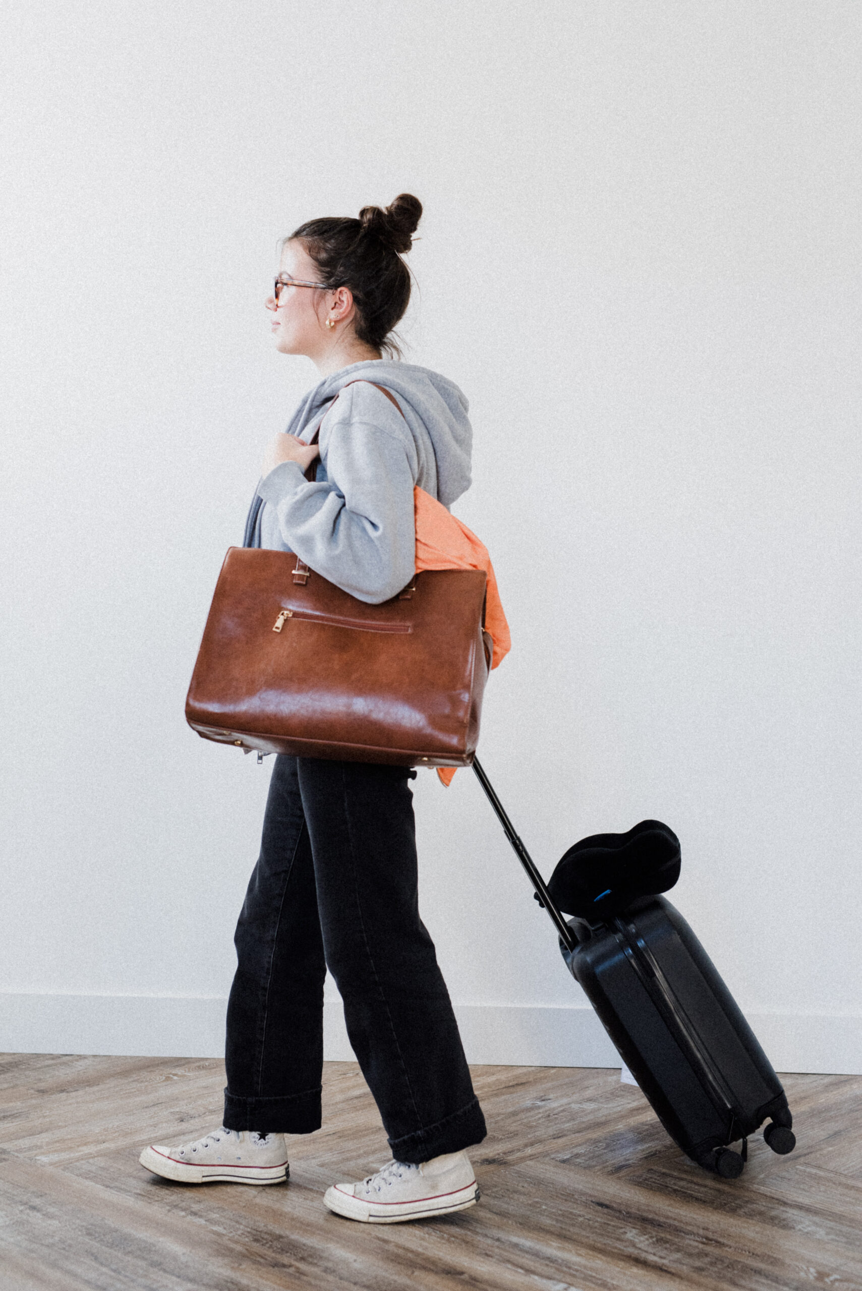 A girl walking with her suitcase after getting her travel medication in Kamloops BC.