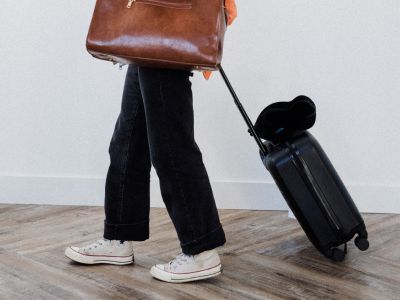A girl walking with her suitcase after getting her travel medication in Kamloops BC.