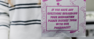 Close-up of a prescription medication bag with a message encouraging patients to speak with a pharmacist about their medications