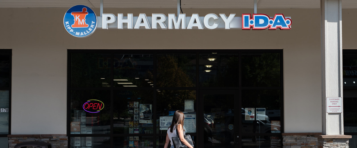 Exterior entrance of Kipp-Mallery I.D.A. Pharmacy in Kamloops, BC, offering prescription services and medication management support.